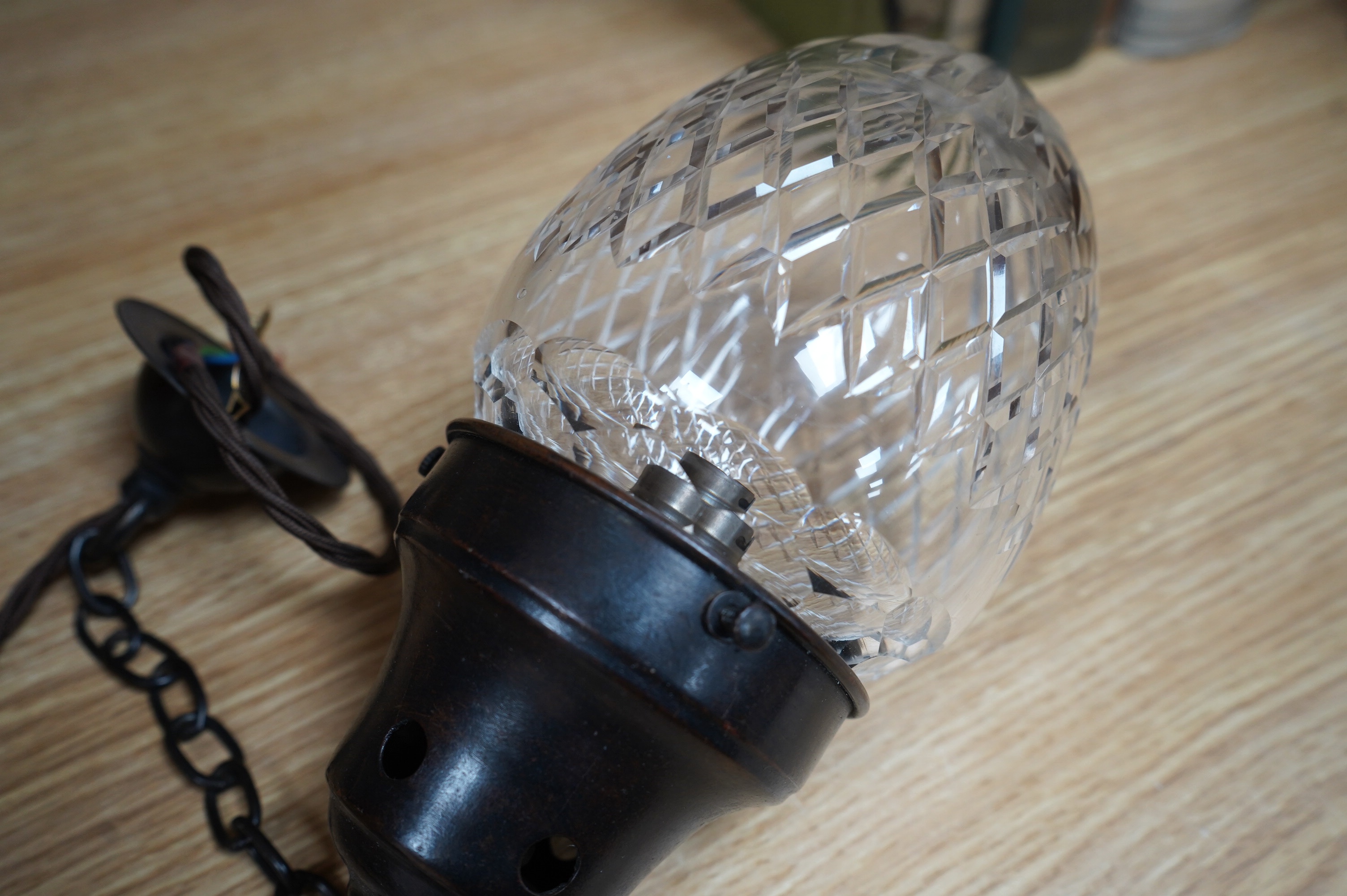 An English 1920’s crystal acorn pendant with gilded bronzed fitting, chain and ceiling rose, wired, glass including gallery 24cm high, 11cm across. Condition - good, not tested